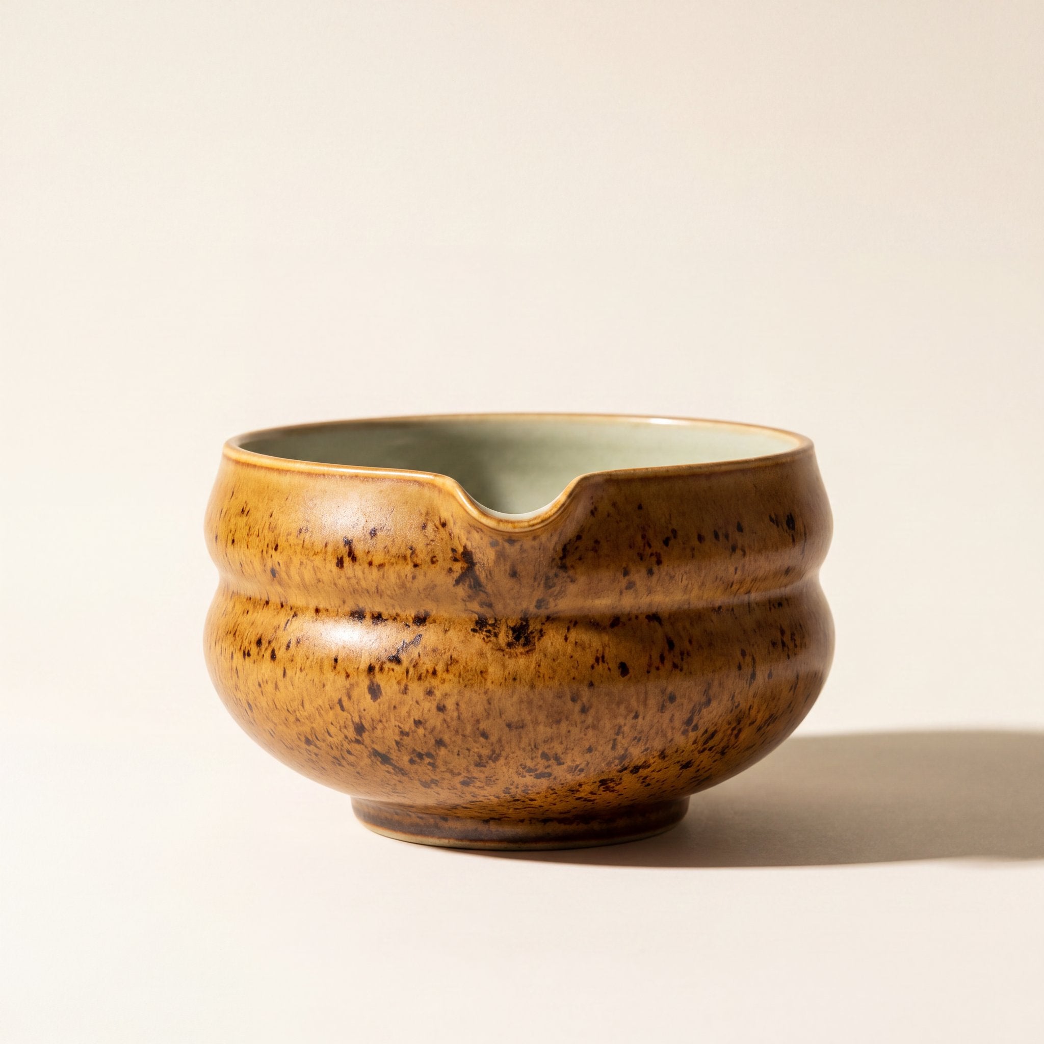 Kumora matcha bowl in Amber, front view showing the pouring spout