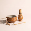 Kumora five-piece matcha set in Amber — bowl, whisk holder, whisk, scoop and sifter