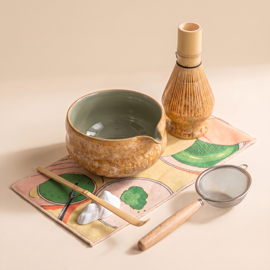 Kumora 7-piece matcha set in Amber — full set styled on the printed mat, spouted bowl with sage-green celadon interior