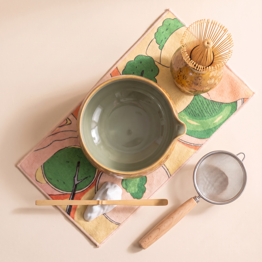 Kumora 7-piece matcha set in Amber — flat top-down view of the whole set, sage-lined amber bowl with spout at right