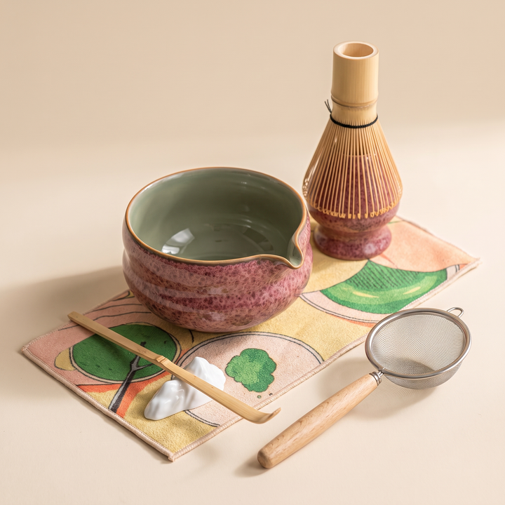 Kumora 7-piece matcha set in Ash Rose — elevated hero of the full set styled on the printed mat