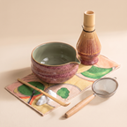 Kumora 7-piece matcha set in Ash Rose — three-quarter view of the spouted bowl, whisk stand, scoop, sifter and rest