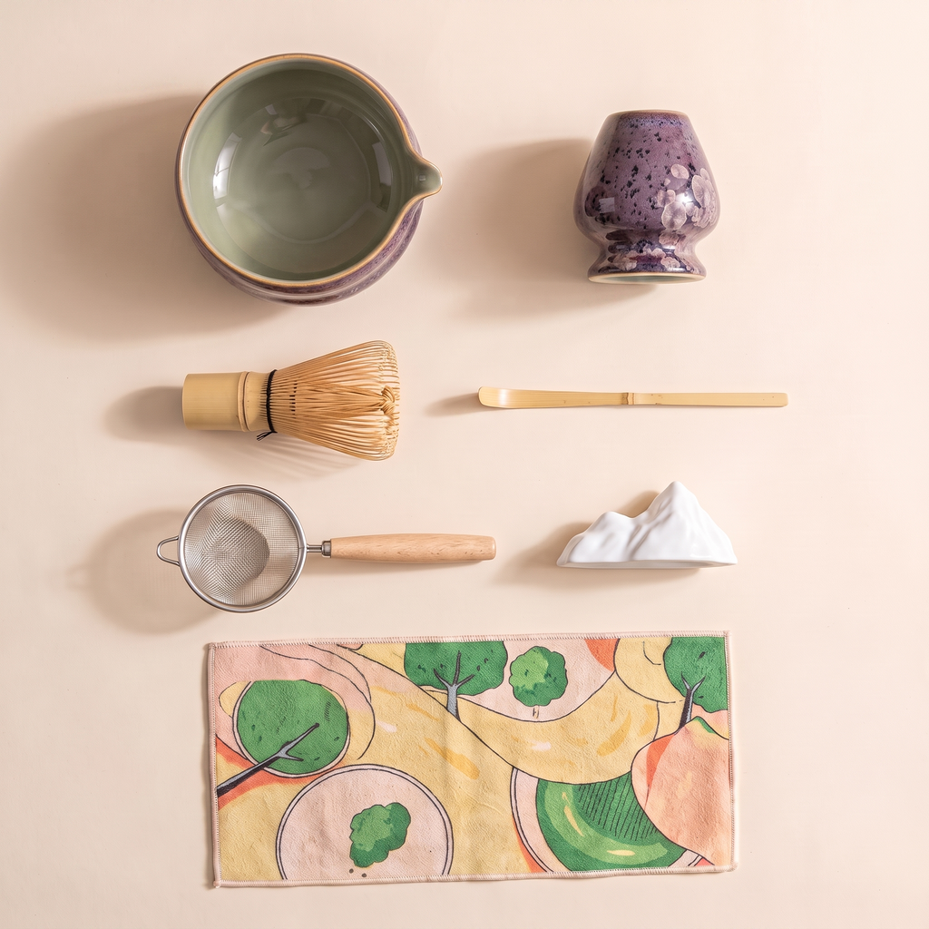 Kumora 7-piece matcha set in Aubergine — overhead flat-lay of all seven pieces, bowl, whisk, scoop, sifter, rest and mat